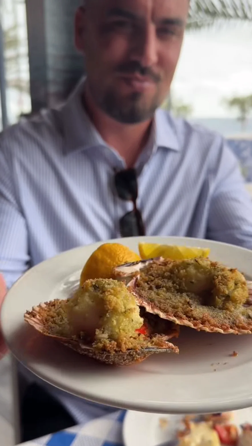 Baked scallops presented at the table