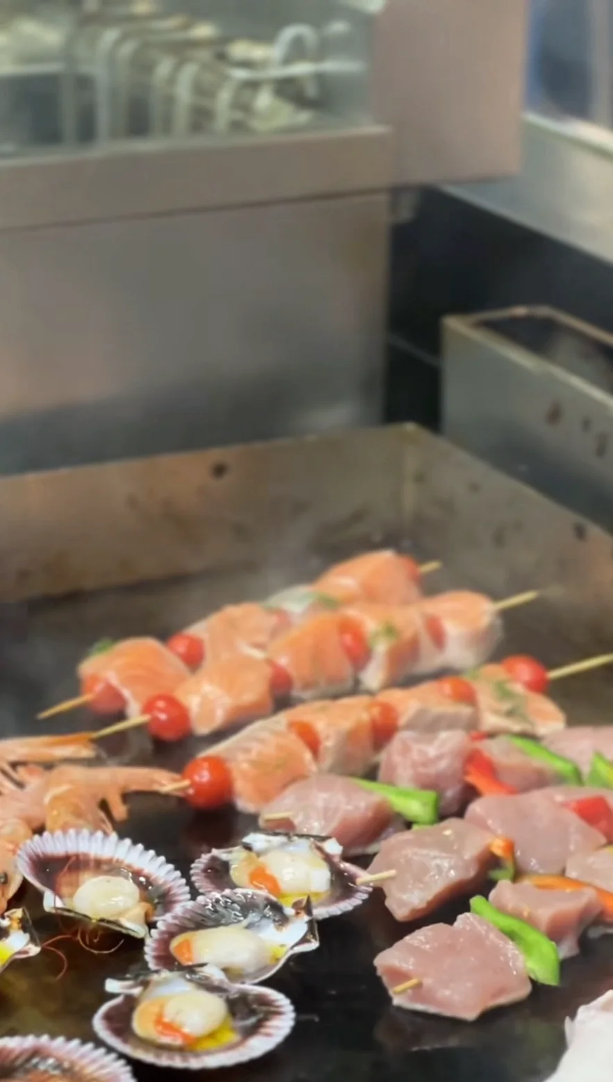 Fresh skewers and scallops on the grill